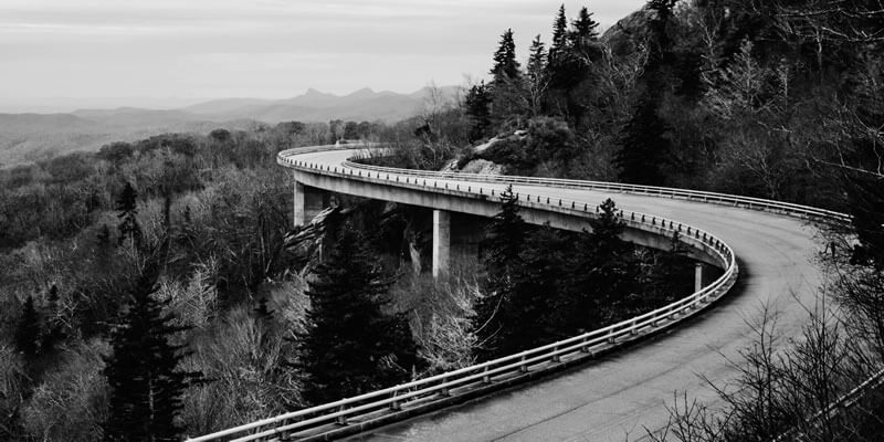 Winding road through mountain forest