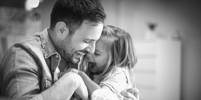 Laughing father and daughter