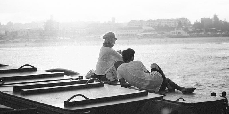 Relaxed couple looking across the ocean to shore