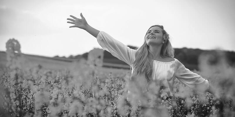 Young woman frolicking in a field