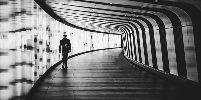 Man walking through contemporary underground passage