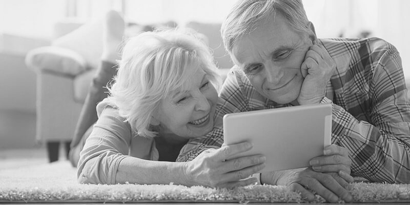 Happy retired couple looking at a document