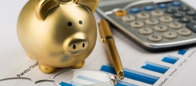 Piggy bank, calculator and pen image