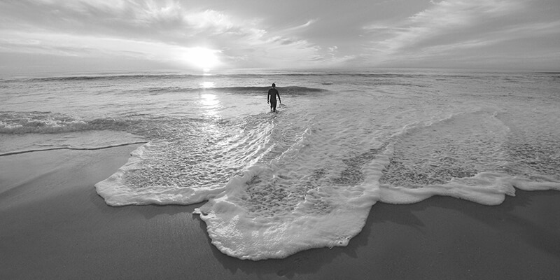 Swimmer walking into the ocean