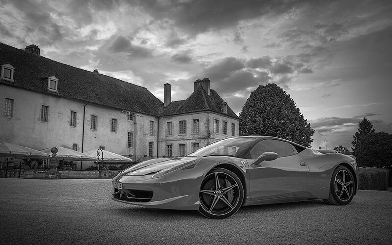 Luxury car outside grand estate